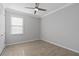 A bedroom featuring tile floors, neutral walls, ceiling fan, and a window at 17826 Blazing Star Cir, Clermont, FL 34714