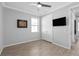 A bedroom features tile floors, neutral walls, a ceiling fan, and a television at 17826 Blazing Star Cir, Clermont, FL 34714