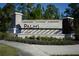 Palms at Serenoa community sign surrounded by lush landscaping and mature trees at 17826 Blazing Star Cir, Clermont, FL 34714