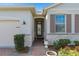 Close up of entrance of home with beautiful landscaping, brick walkway and stone accents at 17826 Blazing Star Cir, Clermont, FL 34714