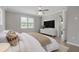 Serene main bedroom features neutral tones, a ceiling fan, and a large window for natural light at 17826 Blazing Star Cir, Clermont, FL 34714