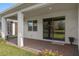 Covered patio featuring brick flooring, white columns, and view of a lake at 17826 Blazing Star Cir, Clermont, FL 34714