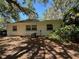Exterior view of the backyard featuring lush greenery and the home's exterior windows at 22 Poinsettia Dr, Deland, FL 32724