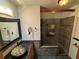 This bathroom features tile floors, mosaic tile, a unique glass bowl sink, and a shower with a rainfall head at 22 Poinsettia Dr, Deland, FL 32724