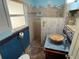 This bath features tile mosaic shower, unique decor, and wood vanity at 22 Poinsettia Dr, Deland, FL 32724