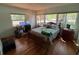 Spacious bedroom featuring natural light, wood floors, and a wooden bed frame at 22 Poinsettia Dr, Deland, FL 32724