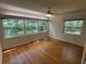 This bedroom offers natural light, hardwood floors, and a ceiling fan for added comfort at 22 Poinsettia Dr, Deland, FL 32724