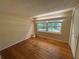 This is a bright bedroom with hardwood flooring and large windows at 22 Poinsettia Dr, Deland, FL 32724