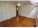 Bedroom with hardwood floors, white walls, a ceiling fan and two closets at 22 Poinsettia Dr, Deland, FL 32724