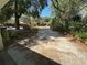 Long driveway leading to the property, framed by mature trees and lush greenery at 22 Poinsettia Dr, Deland, FL 32724
