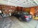 Spacious garage with ample storage shelving and parking for a vehicle at 22 Poinsettia Dr, Deland, FL 32724