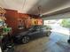 Garage featuring a car and storage on shelves and wall at 22 Poinsettia Dr, Deland, FL 32724