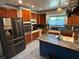 Well-equipped kitchen with stainless steel appliances and wood cabinets at 22 Poinsettia Dr, Deland, FL 32724