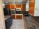 Well-equipped kitchen with stainless steel appliances, wood cabinets, and blue island perfect for culinary enthusiasts at 22 Poinsettia Dr, Deland, FL 32724