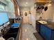 Kitchen featuring granite countertops, blue cabinets, and modern appliances at 22 Poinsettia Dr, Deland, FL 32724