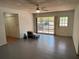 Open-concept living room with light walls, gray tile floors, and natural light at 22 Poinsettia Dr, Deland, FL 32724
