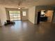 Open living room featuring tile flooring, a ceiling fan, and a view into the kitchen at 22 Poinsettia Dr, Deland, FL 32724