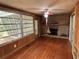Living room showcasing fireplace, decorative mantel, wood floors, and walls of windows bringing in natural light at 22 Poinsettia Dr, Deland, FL 32724