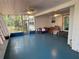 Screened porch with ceiling fans and blue painted concrete floor at 22 Poinsettia Dr, Deland, FL 32724