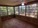 Bright sunroom with wood flooring and large windows at 22 Poinsettia Dr, Deland, FL 32724