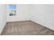 Bright bedroom featuring neutral carpet, white walls, and natural light from the window at 2222 Derwent Dr, Davenport, FL 33896