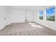 Spacious bedroom featuring neutral carpet, white walls, and natural light from two windows at 2222 Derwent Dr, Davenport, FL 33896