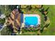 Aerial view of the community pool and lounge area surrounded by palm trees and lounge chairs at 2222 Derwent Dr, Davenport, FL 33896