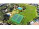 Aerial view of the community pool area, featuring a pool, tennis and volleyball courts at 2222 Derwent Dr, Davenport, FL 33896