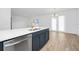 Modern kitchen island featuring white countertop, gold faucet, stainless steel dishwasher, and stylish blue cabinetry at 2222 Derwent Dr, Davenport, FL 33896