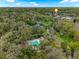 Beautiful aerial view of a neighborhood with a community pool, pond, and lush green surroundings at 229 Springside Rd, Longwood, FL 32779