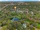 Serene aerial view showcasing the property's location surrounded by lush trees and a nearby pond at 229 Springside Rd, Longwood, FL 32779