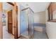 Bathroom with a glass shower stall and tiled bathtub that create a relaxing and functional space at 229 Springside Rd, Longwood, FL 32779