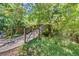 Charming wooden bridge on the property offers picturesque views of nature at 229 Springside Rd, Longwood, FL 32779