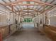 Indoor view of the horse stable with individual stalls and horses at 229 Springside Rd, Longwood, FL 32779