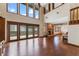 Hardwood floors throughout the living room provide access to a large deck and fireplace at 229 Springside Rd, Longwood, FL 32779