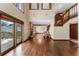 Elegant living room featuring a fireplace, hardwood floors, staircase, and access to an outdoor deck at 229 Springside Rd, Longwood, FL 32779