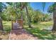 Scenic view of a wooden bridge over a pond surrounded by palm trees at 229 Springside Rd, Longwood, FL 32779