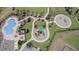 Aerial view of community pool, playground, and well-maintained landscaping at 2305 Biscotto Cir, Davenport, FL 33897