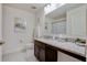 Well-lit bathroom with a granite countertop vanity, modern fixtures, and a clean aesthetic at 2305 Biscotto Cir, Davenport, FL 33897