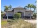 Exterior of the community clubhouse with lush landscaping and ample parking at 2305 Biscotto Cir, Davenport, FL 33897