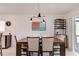 Dining area featuring a wooden table with seating and a modern light fixture at 2305 Biscotto Cir, Davenport, FL 33897