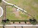 Aerial view of fenced dog park with seating and walking path at 2305 Biscotto Cir, Davenport, FL 33897