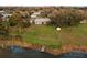 Aerial view of property featuring a large backyard, dock, and waterfront access at 250 Domino Dr, Orlando, FL 32805