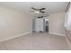 Bedroom with neutral walls, modern ceiling fan, barn-style door and wood-look tiled floors at 250 Domino Dr, Orlando, FL 32805