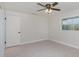 This bedroom has a ceiling fan, a window for natural light, and wood-look floors at 250 Domino Dr, Orlando, FL 32805