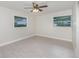 This bedroom features two windows, a ceiling fan, and wood-look floors at 250 Domino Dr, Orlando, FL 32805