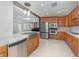 Modern kitchen with stainless steel appliances, marble countertops, and wood cabinets at 250 Domino Dr, Orlando, FL 32805