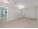 Open-concept living room with neutral walls, decorative chandelier, and wood-look tile flooring at 250 Domino Dr, Orlando, FL 32805