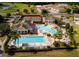 A lovely aerial view of community amenities including pools, tennis courts, and clubhouse at 2610 Rosemont Cir, Davenport, FL 33837