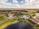 Aerial photograph of a golf course community with a clubhouse, pool, and other amenities at 2610 Rosemont Cir, Davenport, FL 33837